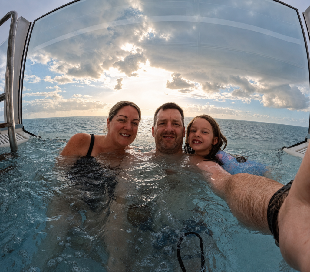 Family relaxing in an infinity hot tub aboard P&O Iona with the sea behind them
