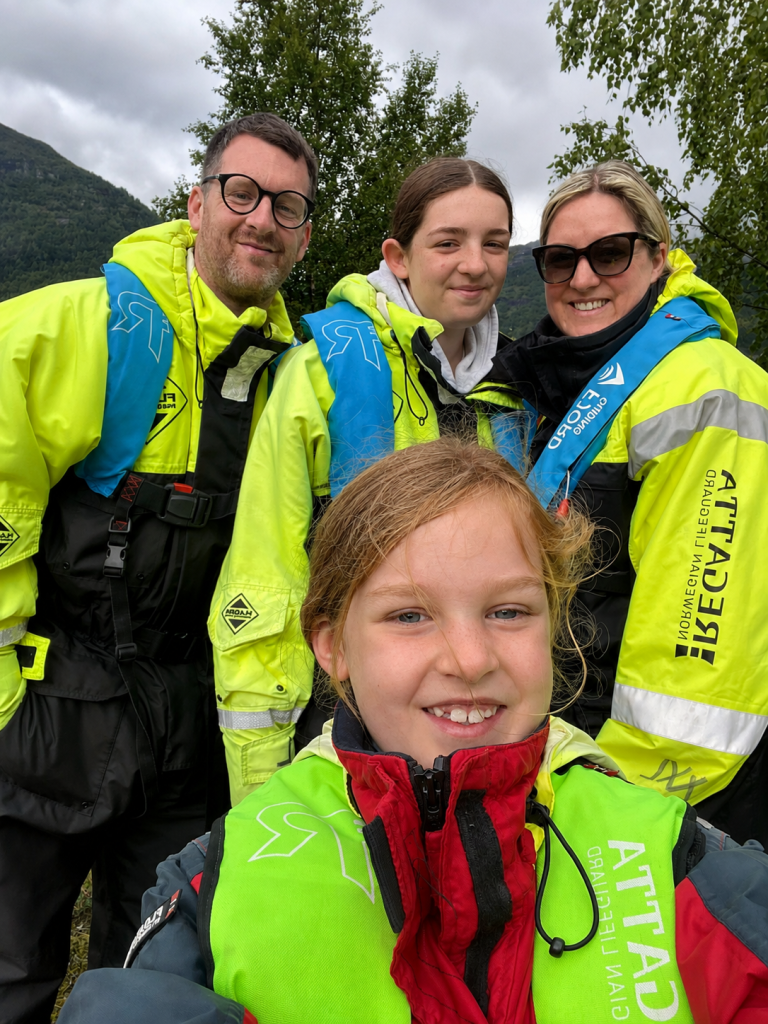 Family wearing waterproof suits and life jackets before a RIB ride in Hellesylt